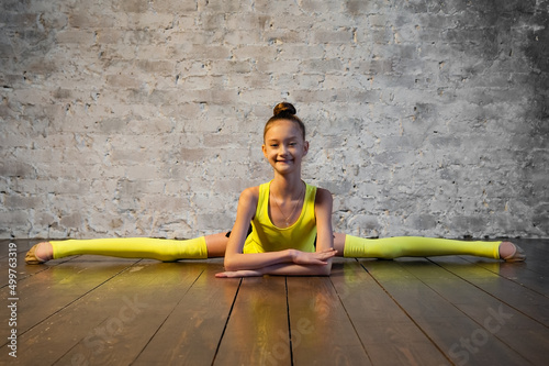 Young gymnast girl stretching and training. Sport and healthy lifestyle concept