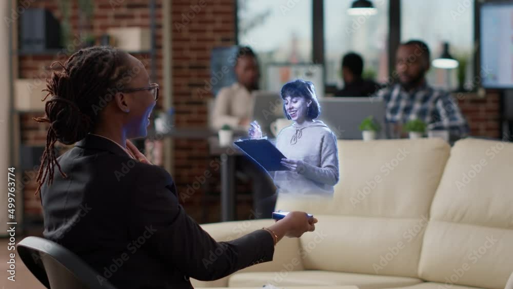 Augmented reality metaverse virtual video conference meeting between business women in start up office using modern hi tech futuristic advanced hologram holographic technology. Online internet future