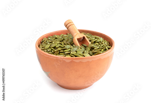Peeled pumpkin seeds in a bowl isolated on a white background. Super food. Healthy food. Copy space