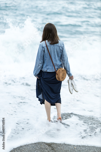 A woman walking into the sea