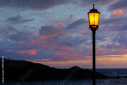 Illuminated Lamp post by beach at sunset, El Cotillo, Fuerteventura, Canary Islands, Spain photo