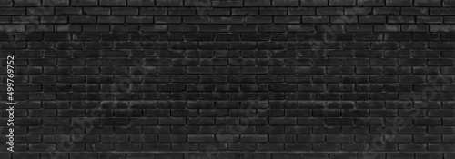 Fotografering Old black messy exterior brick wall wide panoramic texture