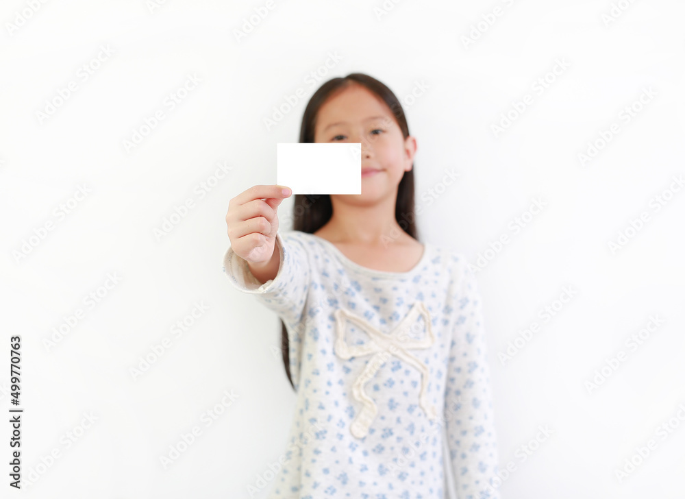 Asian girl kid showing blank white card over white background. Focus at card in child hand Asian girl kid showing blank white card over white background. Focus at card in child hand