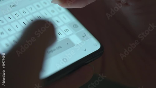 Female hands typing text on smartphone close-up. Using smartphone close up in the evening