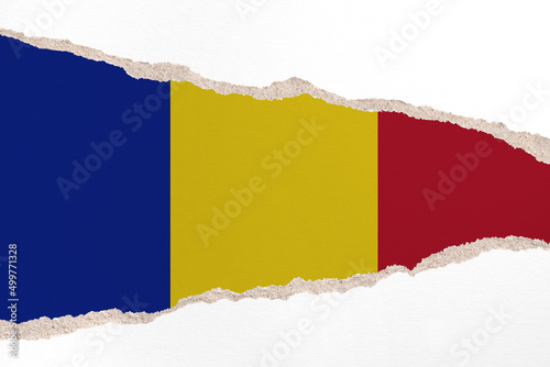 Ripped paper background in colors of national flag. Chad