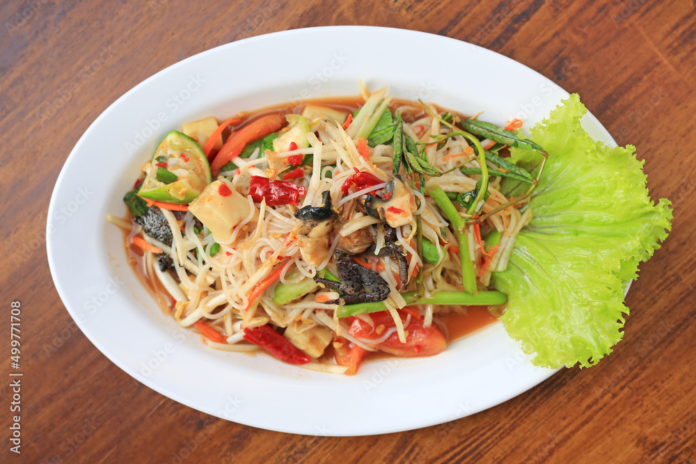 Papaya Salad (Som Tam Pa) the traditional Thai foods on wood table background. Most wanted popular food in Thailand.