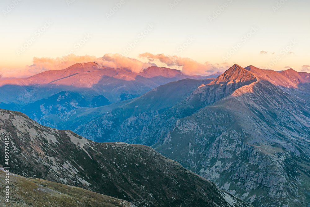 Golden light at sunrise in the mountains (Peak of Puigmal, Pyrenees Mountains) Golden light at sunrise in the mountains (Peak of Puigmal, Pyrenees Mountains)