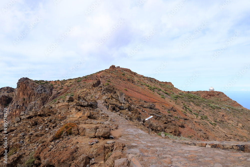 Impressive panoramic landscape of clouds and volcanic mountains from the top of the Roque de los Muchachos viewpoint, on the island of La Palma, Canary Islands, Spain