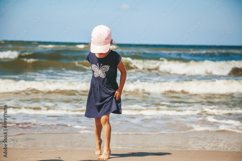 Little girl walking along the beach