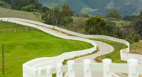 Country road with white picket fence