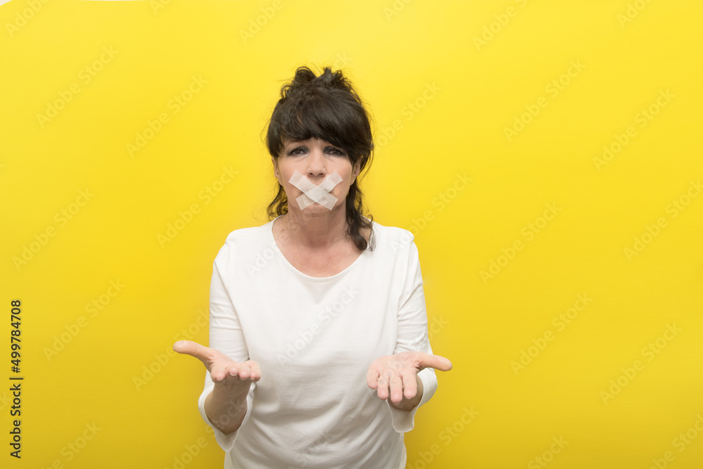 aged woman with a sealed mouth and outstretched arms in a begging gesture, the concept of tyranny, despotism, censorship, asking for help aged woman with a sealed mouth and outstretched arms in a begging gesture, the concept of tyranny, despotism, censorship, asking for help
