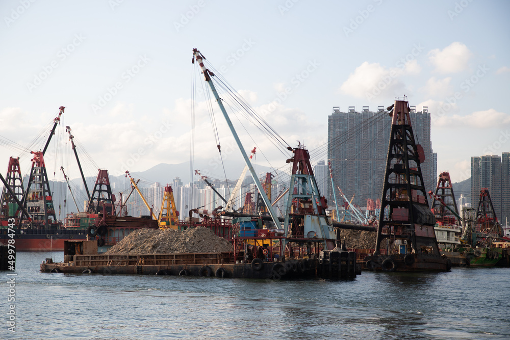 various marine vessel or dredger fitted with devices to scrap or suck the sediment or transport fill materials for land reclamation