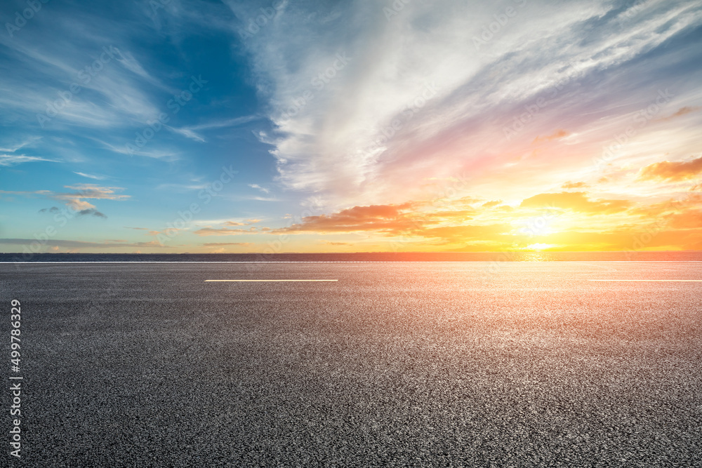 Asphalt road and lake with sky clouds nature landscape at sunset