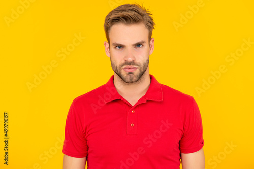 portrait of man with bristle in red shirt. serious young man with beard