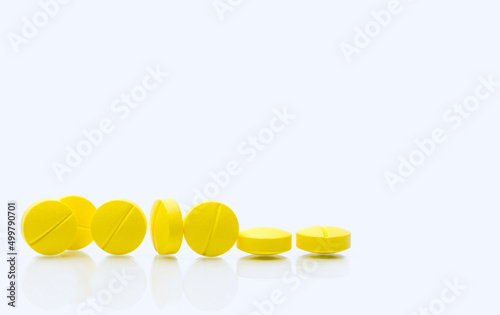 Yellow tablets pills on white background. Prescription drugs. Pharmaceutical industry. Healthcare and medicine. Pharmacy drugstore web banner. Tablets pills manufacturing industry. Healthcare industry photo