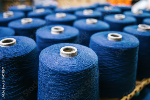 Cotton yarns or threads on spool tube bobbins at cotton yarn factory. photo