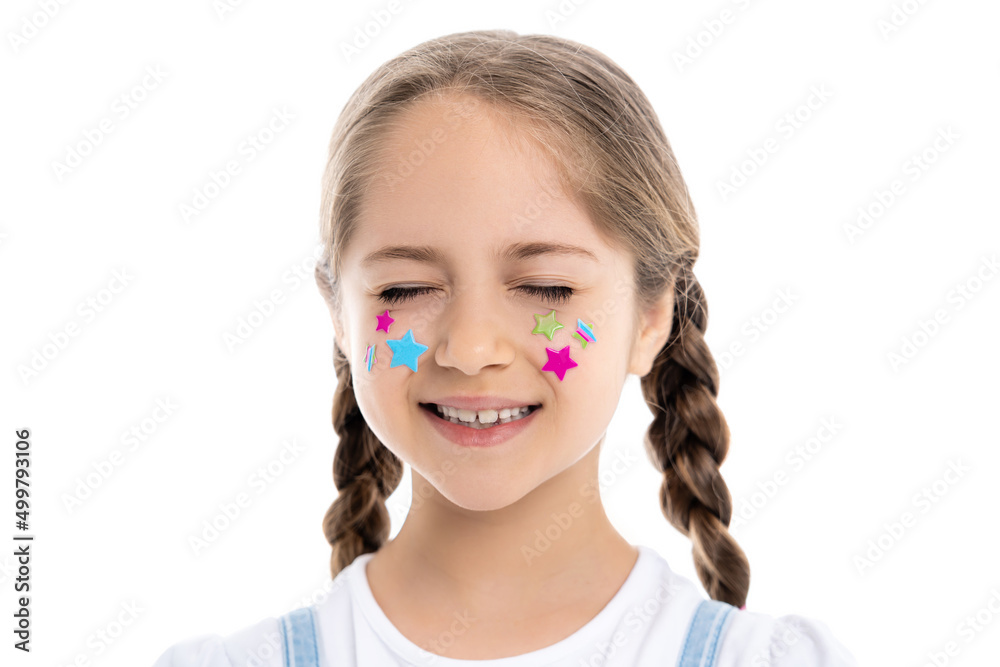 girl with closed eyes and multicolored stars on face smiling isolated on white. girl with closed eyes and multicolored stars on face smiling isolated on white.