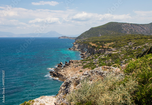View of the coastline and cliffs in the Mediterranean sea in sunny day with blue sky, Greece 