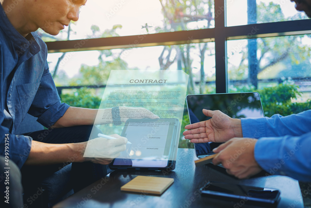 Businessman with digital pencil to puts signature on digital electronic contract in digital tablet. Business investment concept.