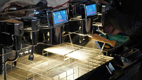 Espresso machine pouring coffee into a mug in a Restaurant in Berlin, Germany.