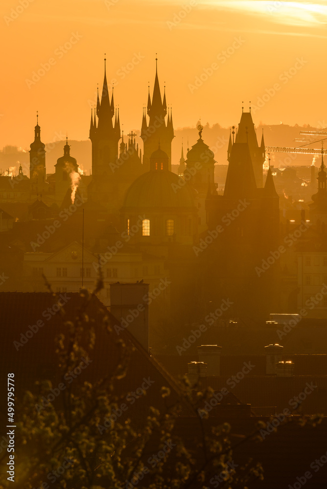 A Prague cityscape in the strong sunrise light.