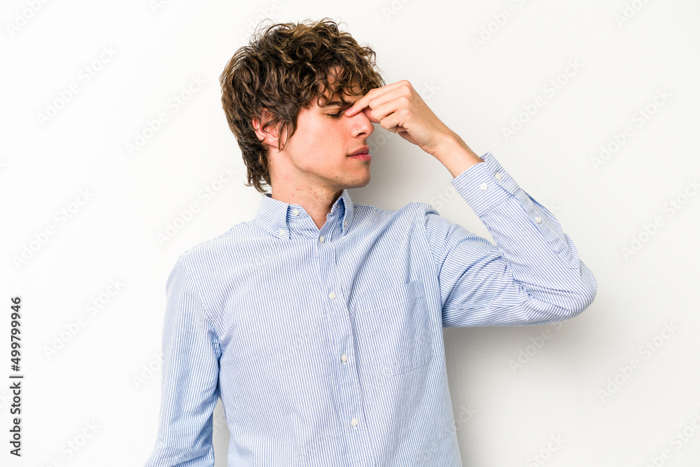 Young caucasian man isolated on white background having a head ache, touching front of the face. Young caucasian man isolated on white background having a head ache, touching front of the face.
