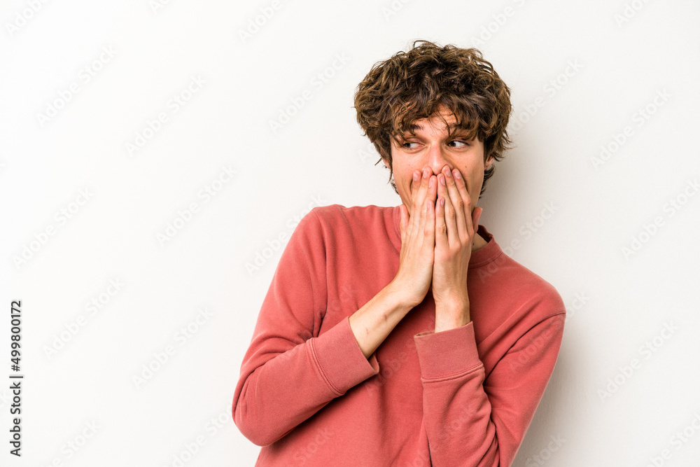 Young caucasian man isolated on white background laughing about something, covering mouth with hands. Young caucasian man isolated on white background laughing about something, covering mouth with hands.