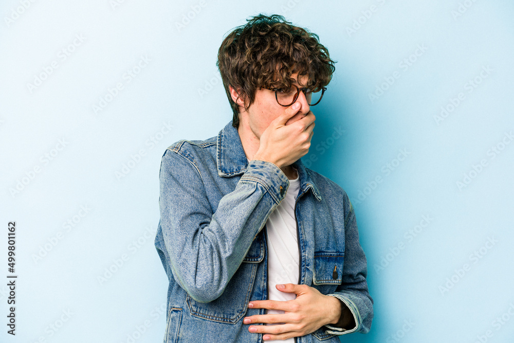 Young caucasian man isolated on blue background scared and afraid. Young caucasian man isolated on blue background scared and afraid.