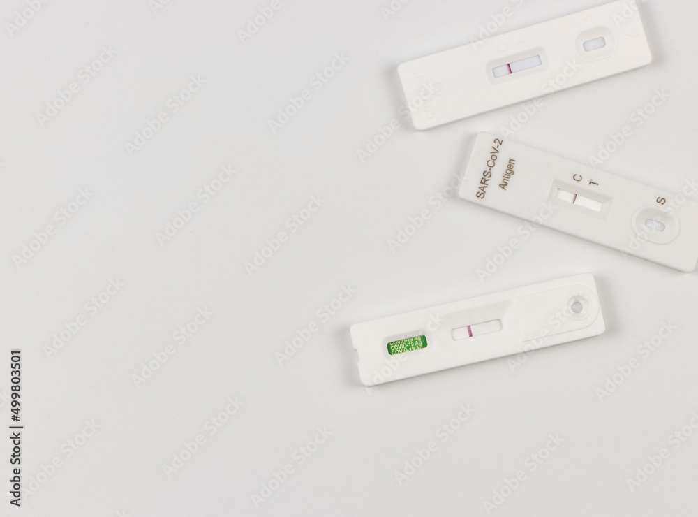 flat lay of Covid-19 three negative test result antigen test kits (ATK) on white background with copy space. Antigen test kits for self collect nose swab. flat lay of Covid-19 three negative test result antigen test kits (ATK) on white background with copy space. Antigen test kits for self collect nose swab.