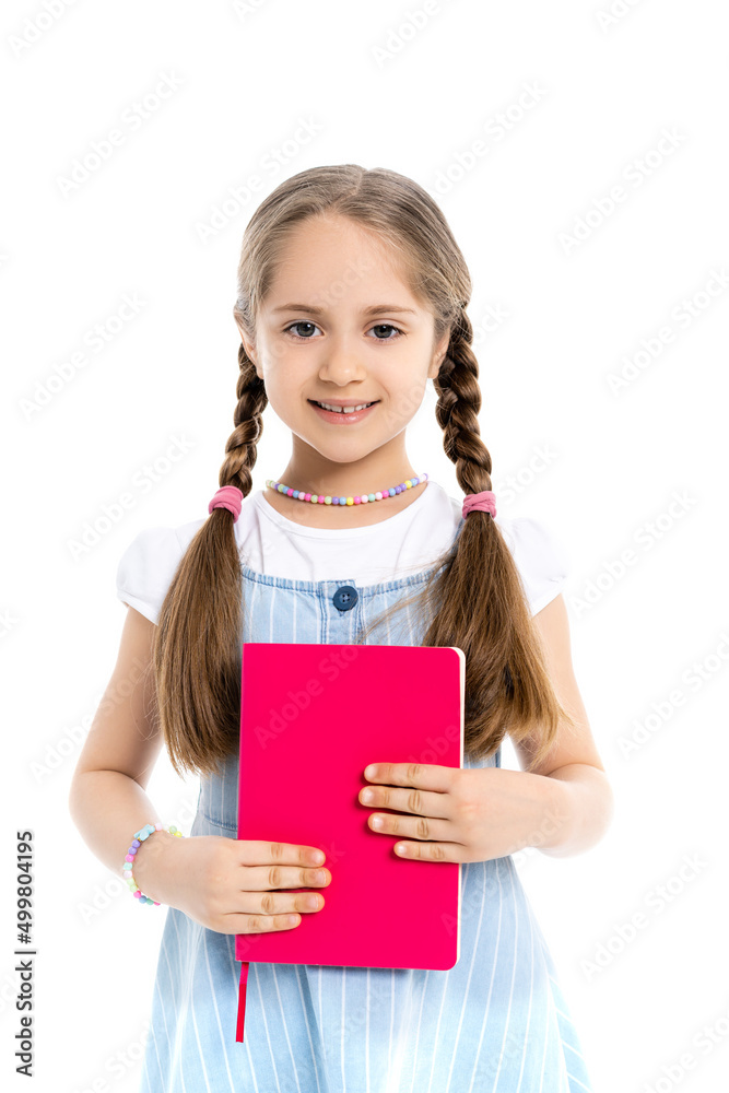 girl with braids holding bright pink notebook and smiling at camera isolated on white. girl with braids holding bright pink notebook and smiling at camera isolated on white.
