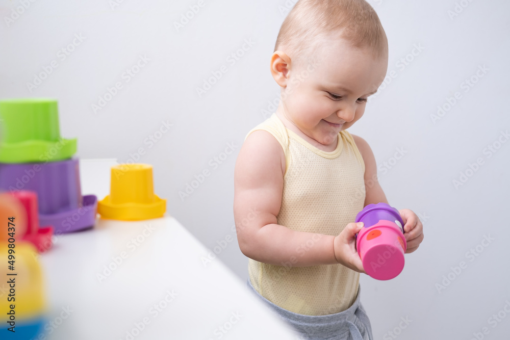 Cute kid girl playing in colorful plastic toys at home. Early childhood development Cute kid girl playing in colorful plastic toys at home. Early childhood development