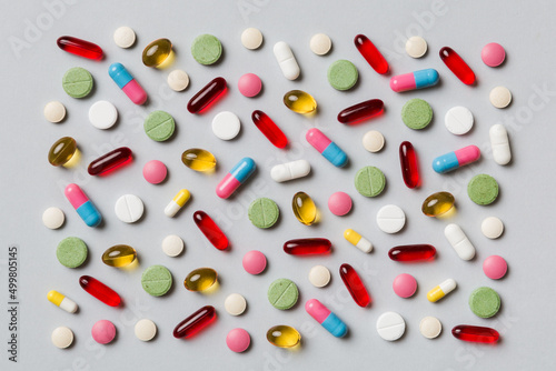 Many different pills and space for text on colorful background, top view. Different pills on color background, flat lay