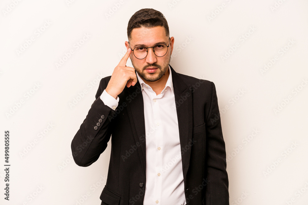 Business hispanic man isolated on white background pointing temple with finger, thinking, focused on a task. Business hispanic man isolated on white background pointing temple with finger, thinking, focused on a task.