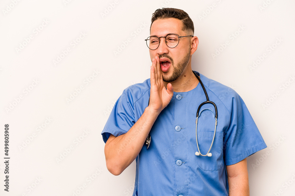 Hispanic nurse man isolated on white background is saying a secret hot braking news and looking aside Hispanic nurse man isolated on white background is saying a secret hot braking news and looking aside