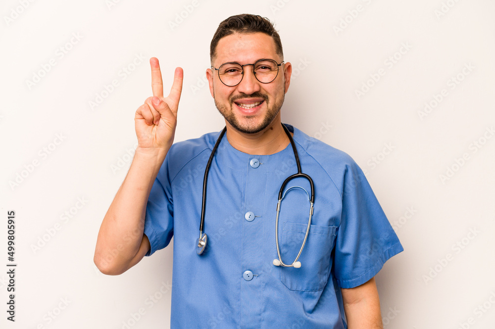 Hispanic nurse man isolated on white background showing number two with fingers. Hispanic nurse man isolated on white background showing number two with fingers.
