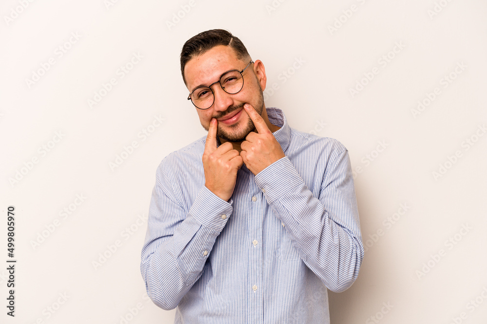 Young hispanic man isolated on white background doubting between two options. Young hispanic man isolated on white background doubting between two options.
