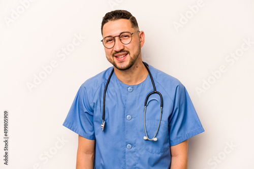 Hispanic nurse man isolated on white background happy, smiling and cheerful.