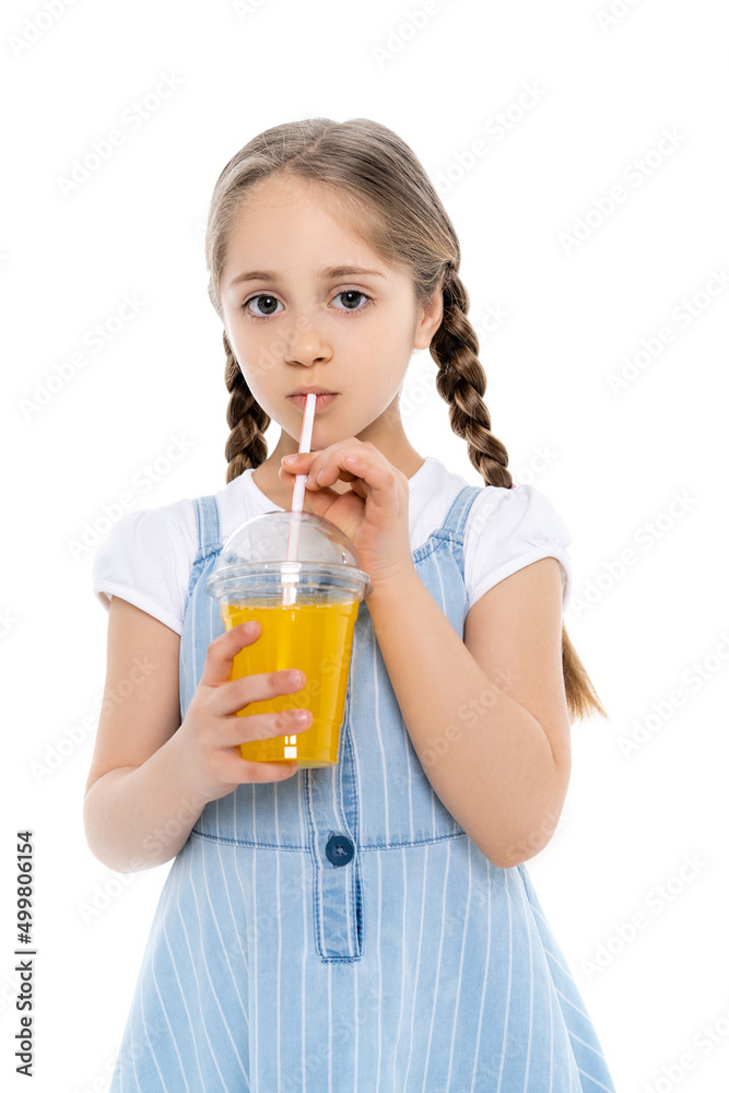 girl in blue strap dress drinking orange juice and looking at camera isolated on white. girl in blue strap dress drinking orange juice and looking at camera isolated on white.