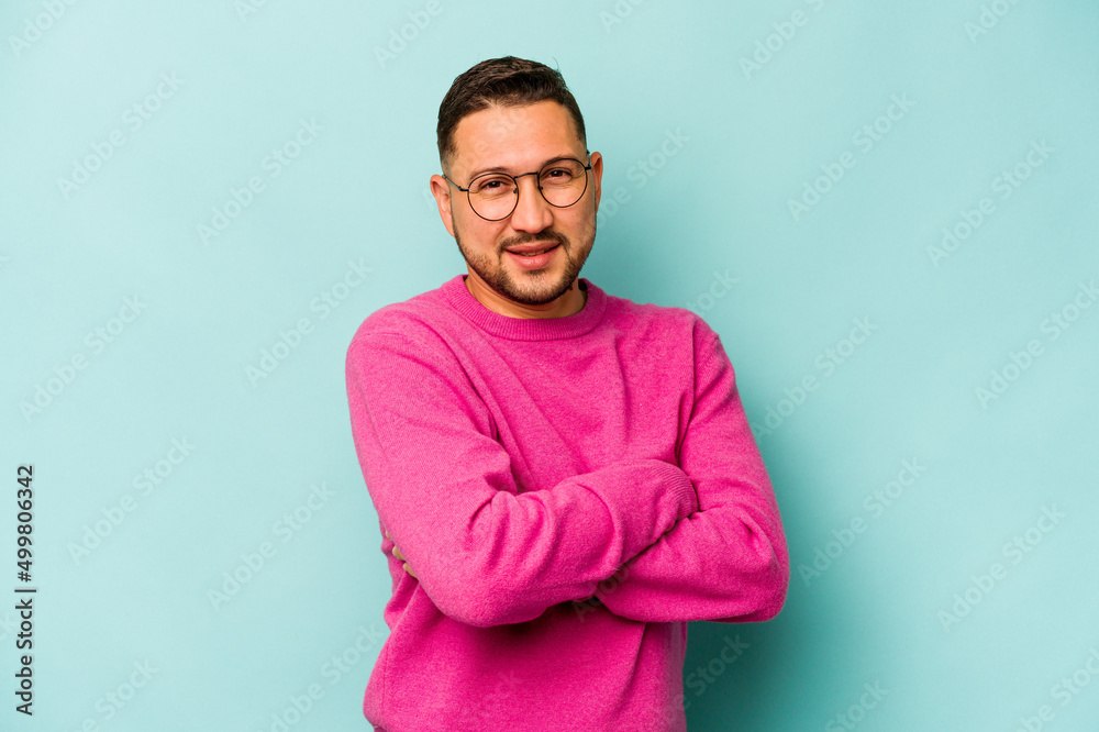 Young hispanic man isolated on blue background happy, smiling and cheerful. Young hispanic man isolated on blue background happy, smiling and cheerful.