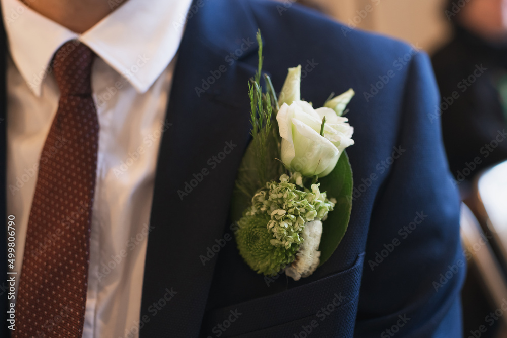 Groom at a wedding with a boutonniere of white eustoma Groom at a wedding with a boutonniere of white eustoma