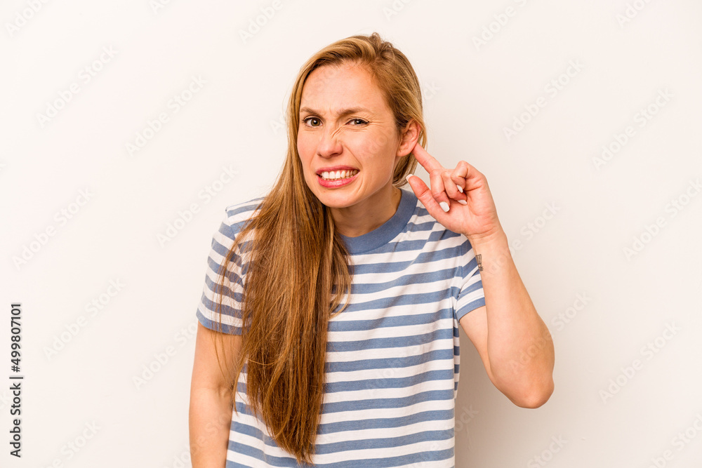 Young caucasian woman isolated on white background covering ears with fingers, stressed and desperate by a loudly ambient. Young caucasian woman isolated on white background covering ears with fingers, stressed and desperate by a loudly ambient.