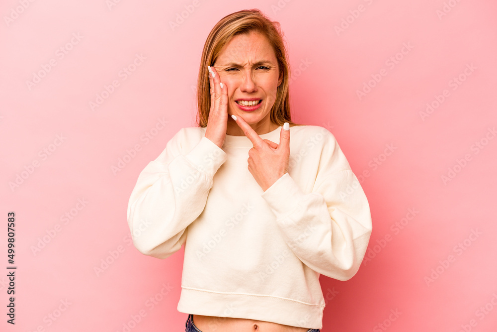 Young caucasian woman isolated on pink background having a strong teeth pain, molar ache. Young caucasian woman isolated on pink background having a strong teeth pain, molar ache.