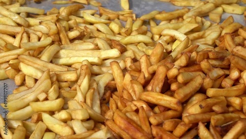 Potato fries. Fried potatoes sold at a festival. High-calorie, fatty, unhealthy, fast-food snack.