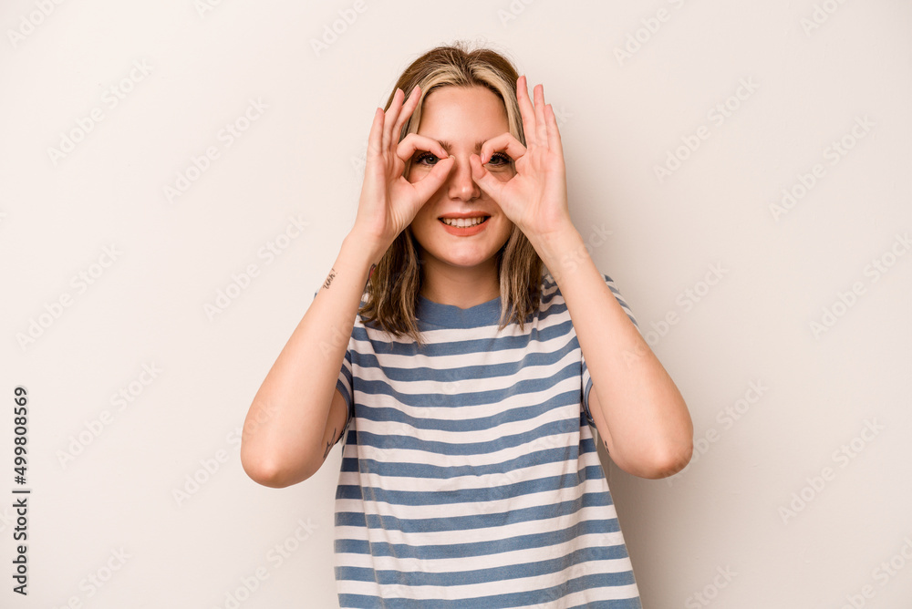 Young caucasian woman isolated on white background excited keeping ok gesture on eye. Young caucasian woman isolated on white background excited keeping ok gesture on eye.