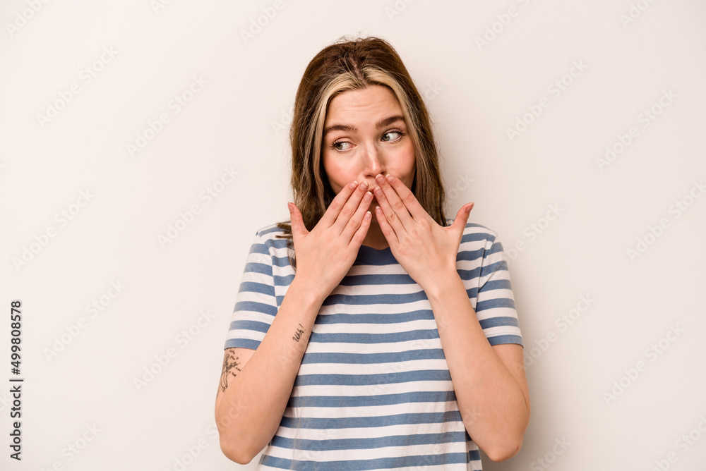 Young caucasian woman isolated on white background laughing about something, covering mouth with hands. Young caucasian woman isolated on white background laughing about something, covering mouth with hands.