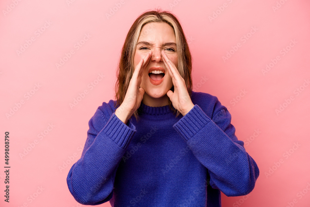 Young caucasian woman isolated on pink background shouting excited to front. Young caucasian woman isolated on pink background shouting excited to front.