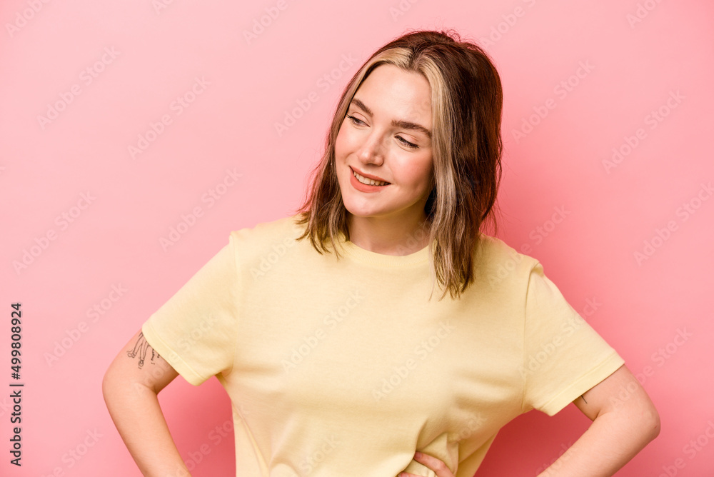 Young caucasian woman isolated on pink background confident keeping hands on hips. Young caucasian woman isolated on pink background confident keeping hands on hips.