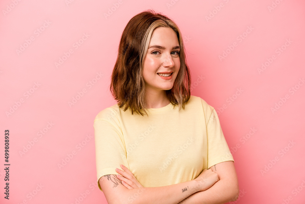 Young caucasian woman isolated on pink background who feels confident, crossing arms with determination. Young caucasian woman isolated on pink background who feels confident, crossing arms with determination.