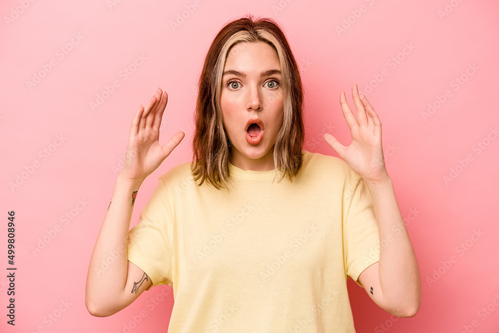 Young caucasian woman isolated on pink background celebrating a victory or success, he is surprised and shocked. Young caucasian woman isolated on pink background celebrating a victory or success, he is surprised and shocked.