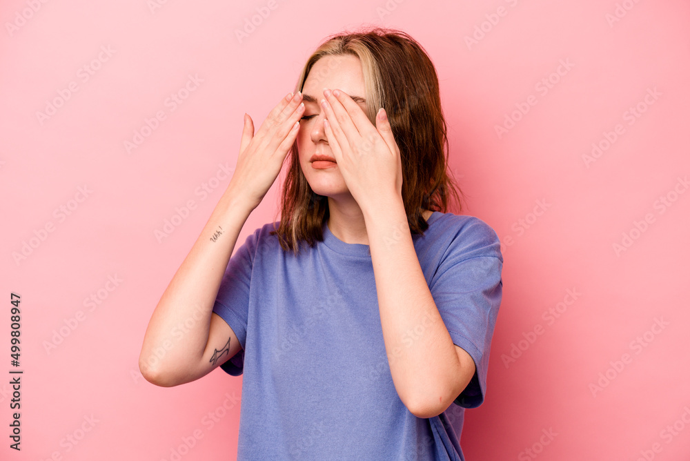 Young caucasian woman isolated on pink background afraid covering eyes with hands. Young caucasian woman isolated on pink background afraid covering eyes with hands.